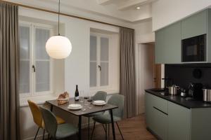 a kitchen and dining room with a table and chairs at AMIRA Ca' Argento Premium Apartments in Trieste Center in Trieste