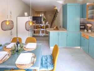 a kitchen with blue cabinets and a table and chairs at LITSA in Iraklitsa