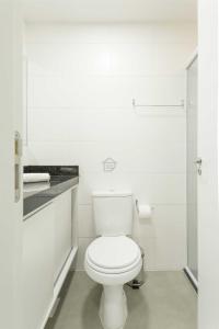 a white bathroom with a toilet and a shower at Edifício Link by Rezervo in Santo Antônio +26 photos