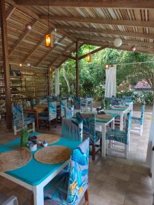 a restaurant with blue tables and blue chairs at Escape Caribeño in Puerto Viejo