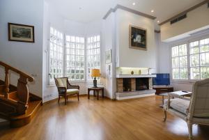a living room with white walls and a fireplace at Villa COLONIAL in Vilaseca de Solcina
