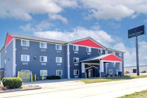 a large blue building with a red roof at Burgundy Inn & Suites in El Paso