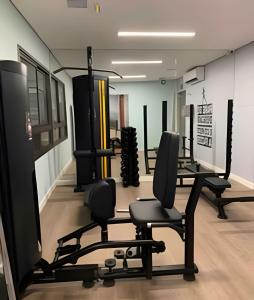a gym with chairs and equipment in a room at Para quem deseja conforto e bem estar in Salvador
