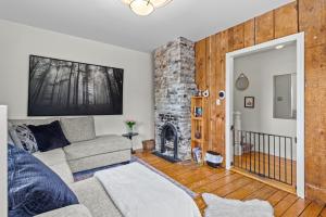 a living room with a couch and a fireplace at Victoria House Signal Hill King Bbq in St. John's