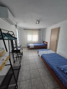 a room with two bunk beds and a desk at The Blue Pearl in Prinos +17 photos