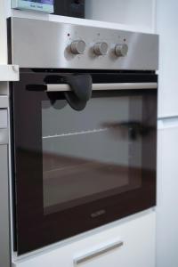 a oven with a glass door in a kitchen at Apparemment T2 in Albertville +4 photos