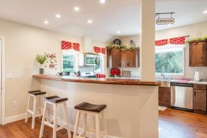 a kitchen with a large counter and stools at a bar at White Fern in New Waterford