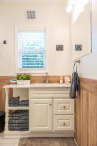 a bathroom with a sink and a window at White Fern in New Waterford +32 photos