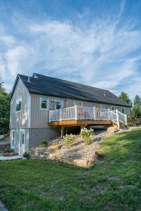 a large house with a deck on the side of it at White Fern in New Waterford