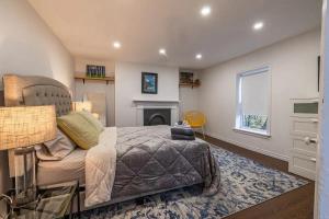 a bedroom with a bed and a fireplace at The Bannerman Park Suite And Loft in St. John's
