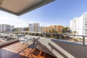uma varanda com mesa e cadeiras na varanda em Praia da Rocha Beach Step em Portimão