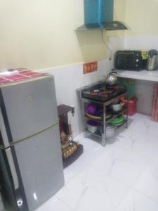 a kitchen with a refrigerator and a stove at Homestay Srey Mom in Kampot