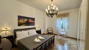a bedroom with a bed with two towels on it at Home Jocy Spacious 3 Bed rooms Apartment with private Parking Ideal for Groups in Castellammare di Stabia