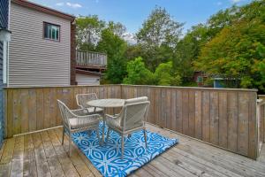 a patio with a table and chairs on a wooden deck at Pennywell Prestige 3 Bed 15 Bath Garage in St. John's