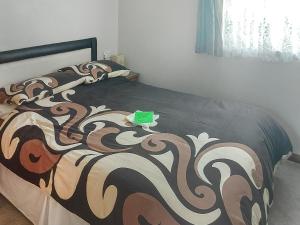 a bedroom with a bed with a black and brown blanket at Summer Time in Brundall
