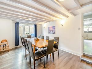 a dining room with a wooden table and chairs at Northstead Lodge in Flamborough