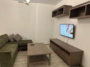 a living room with a couch and a coffee table at Studio Luna in Chiajna