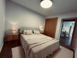 a bedroom with a bed and a table with a chair at Vida in Tarajalejo