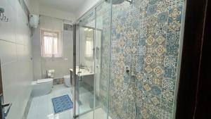 a bathroom with a shower and a toilet at Home Jocy Spacious 3 Bed rooms Apartment with private Parking Ideal for Groups in Castellammare di Stabia