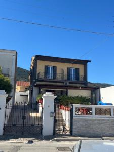 a house with a gate and a fence at Villa Fava in Falciano del Massico