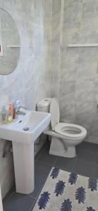 a bathroom with a toilet and a sink at Barefoot Beach House in Larnaka +18 photos