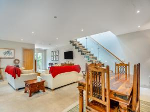 a living room with a couch and a staircase at Ash Hill - Uk36199 in Fordingbridge