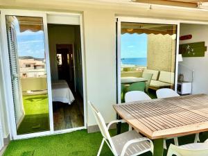 a dining room with a table and a view of the ocean at Beachsuite in Poris de Abona