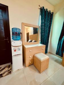 een badkamer met een wastafel en een aanrecht met een spiegel bij gill house in Multan