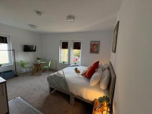a bedroom with a bed with pillows and a table at Central Peterborough Studio 2 in Peterborough
