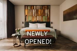 a bedroom with a bed with anever opened sign on it at The Cyrus Hotel in Wrocław