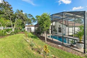 a house with a swimming pool in a yard at The Palms at Eastwood in Palm Coast