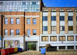a group of buildings on a city street at Executive North London Southgate Serviced Apartment - Contractors Ready in East Barnet
