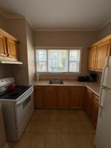 a kitchen with a sink and a stove top oven at Westmount Manor Unit 1 - 2 Bedroom Apartment in St. John's +6 photos
