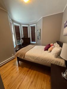 a bedroom with a large bed and wooden floors at Westmount Manor Unit 1 - 2 Bedroom Apartment in St. John's