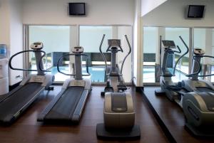 a gym with several treadmills in a building at NH Collection Santiago de Compostela in Santiago de Compostela