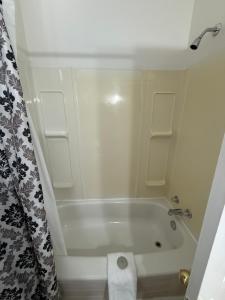 a white bathroom with a tub and a shower at Westmount Manor Unit 2 - 2 Bedroom Apartment in St. John's
