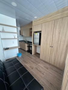 a living room with a tv and a kitchen at Castellana 504 in Bogotá
