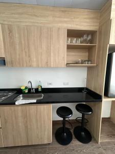 a kitchen with two stools and a counter top at Castellana 504 in Bogotá