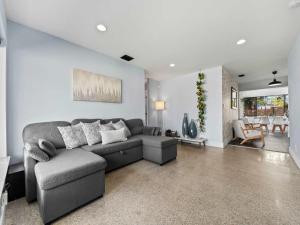 a living room with a couch and a dining room at Luxury Stay with Filtered Water & Pet-Friendly Fun in Fort Lauderdale +33 photos