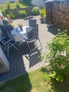 a patio with a table and chairs on a patio at La Casa in Medebach +2 photos