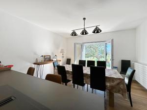 a dining room with a table and chairs at The Gathering Lodge - Crans Montana - Swiss Alps in Lens