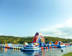 a bunch of inflatable water slides in the water at Canastro do Carvalho in Anissó