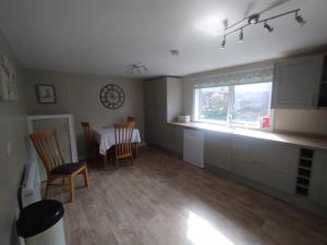 a kitchen and dining room with a table and chairs at Stornoway Townhouse in Stornoway