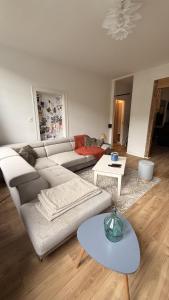 a living room with a couch and a table at L horizon d Aristide - 1 Chambre in Tulle