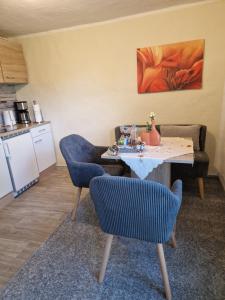 a living room with a table and two chairs at Ferienwohnungen Christine Knoll in Bad Frankenhausen +7 photos