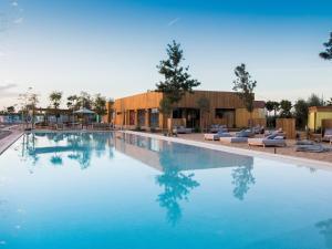 a swimming pool with blue water and lounge chairs at Waky Marrakech Villa in El Rhechat