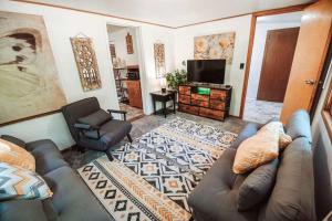 a living room with a couch and a television at Secluded Cabin Getaway in Arkdale in New Rome