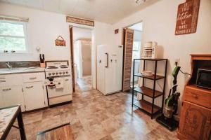 a kitchen with a white refrigerator and a stove at Secluded Cabin Getaway in Arkdale in New Rome
