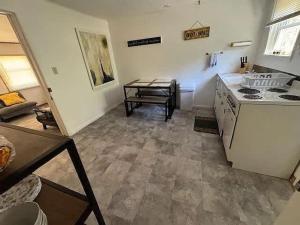 a kitchen with a stove and a table in it at Secluded Cabin Getaway in Arkdale in New Rome +4 photos