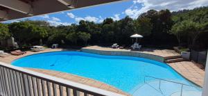 a large blue swimming pool on a balcony at Studio 14 @ The Dunes in Plettenberg Bay